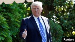 U.S. President Donald Trump gestures as he walks on the South Lawn of the White House in Washington, DC, U.S., before his departure to Groton, Connecticut, May 17, 2017.