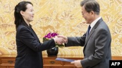 North Korean leader Kim Jong Un's sister Kim Yo Jong hands an autographed letter from Kim Jong Un to South Korea's President Moon Jae-in during their meeting at the presidential Blue House in Seoul, Feb. 10, 2018.