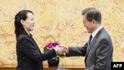 FILE - North Korean leader Kim Jong Un's sister Kim Yo Jong hands an autographed letter from Kim Jong Un to South Korea's President Moon Jae-in during their meeting at the presidential Blue House in Seoul, Feb. 10, 2018.