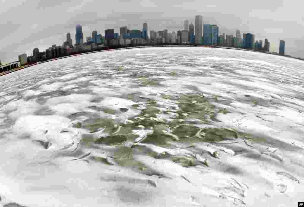 With the Chicago skyline as a backdrop, the swirling waves of Lake Michigan are frozen near the Adler Planetarium after a winter storm in the greater Chicago area, USA, Feb. 22, 2013.