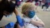 FILE - A patient receives a COVID-19 vaccine booster during a Pfizer-BioNTech vaccination clinic in Southfield, Michigan, September 29, 2021.