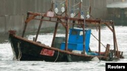 A wooden boat, which according to a police official carried eight men who said they were from North Korea and appear to be fishermen whose vessel ran into trouble, is seen near a breakwater in Yurihonjo, Akita Prefecture, Japan, Nov. 24, 2017. 