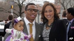 In this March 11, 2013 file photo, Baltimore Ravens running back Ray Rice, left, poses with his daughter, Rayven, and Janay Palmer.