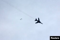 FILE - A warplane loyal to Syria's President Bashar al-Assad fires rockets during an air strike in eastern Al-Ghouta, near Damascus January 25, 2015.