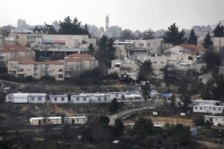FILE - This photo taken on January 25, 2017 shows a partial view of the Israeli settlement of Beit El near the West Bank city of Ramallah (background).