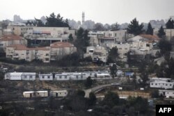FILE - This photo taken on January 25, 2017 shows a partial view of the Israeli settlement of Beit El near the West Bank city of Ramallah (background).