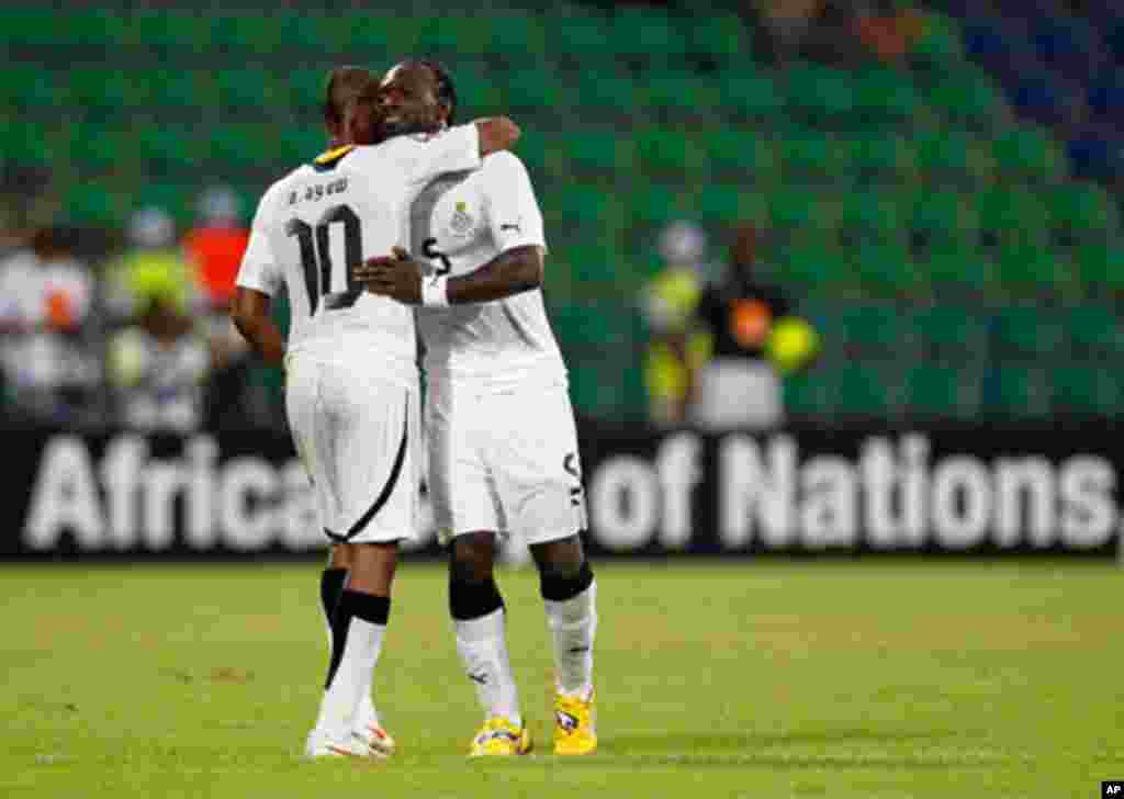 Ghana's Andre Ayew embraces John Mensah after Mensah was red carded during their African Cup of Nations Group D soccer match against Botswana in FranceVille Stadium