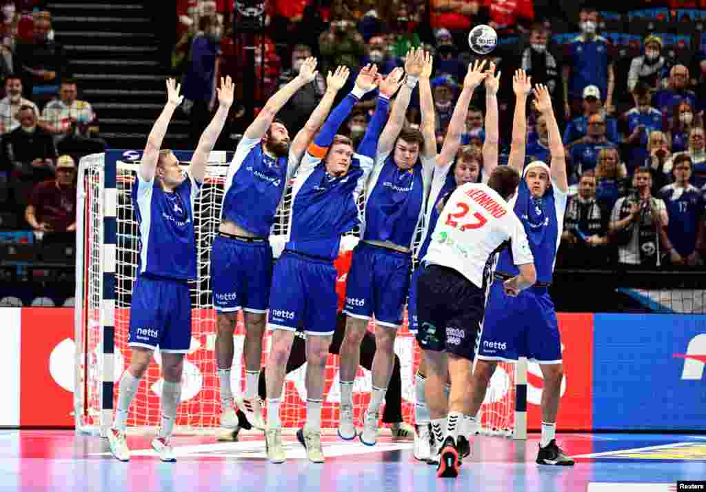 Iceland players form a defensive wall against Norway&#39;s Harald Reinkind during a placement match in the EHF 2022 Men&#39;s European Handball Championship, at the Budapest Handball Arena, in Budapest, Hungary.
