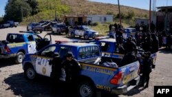 Police officers are seen near Chiquix village, where 13 people were killed, in Nahuala, Guatemala, on December 19, 2021. 