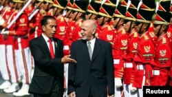 Afghanistan's President Mohammad Ashraf Ghani (R), accompanied by Indonesia's President Joko Widodo, inspects the guard of honor during a welcoming ceremony at the Presidential Palace in Jakarta, Indonesia, April 5, 2017.