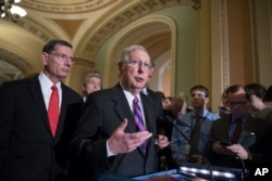 FILE - Senate Majority Leader Mitch McConnell of Kentucky, joined by, from left, Sen. John Barrasso, R-Wyo., and Sen. Roy Blunt, R-Mo., holds a news conference on Capitol Hill in Washington, Aug. 1, 2017.