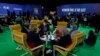 Delegates speak to each other in the Action Zone at the COP26 U.N. Climate Summit, in Glasgow, Scotland, Nov. 10, 2021. 