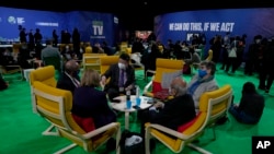 Delegates speak to each other in the Action Zone at the COP26 U.N. Climate Summit, in Glasgow, Scotland, Nov. 10, 2021. 