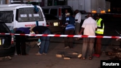 FILE - Bomb experts carry out investigations at the scene of an explosion along Biashara street in the Kenyan coastal city of Mombasa, May 22, 2014.