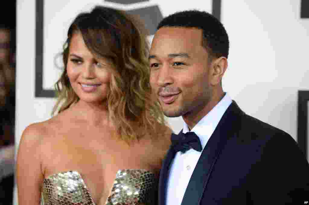 Christine Teigen, left, and John Legend arrive at the 56th annual GRAMMY Awards at Staples Center on Jan. 26, 2014, in Los Angeles.