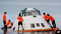 Rescue personnel from the Human Space Flight Support division perform a sea rescue exercise with the Boeing CST-100 Starliner training capsule at the Cape Canaveral Air Force Station Tuesday, April 23, 2019, in Cape Canaveral, Fla. (AP Photo/John Raoux)