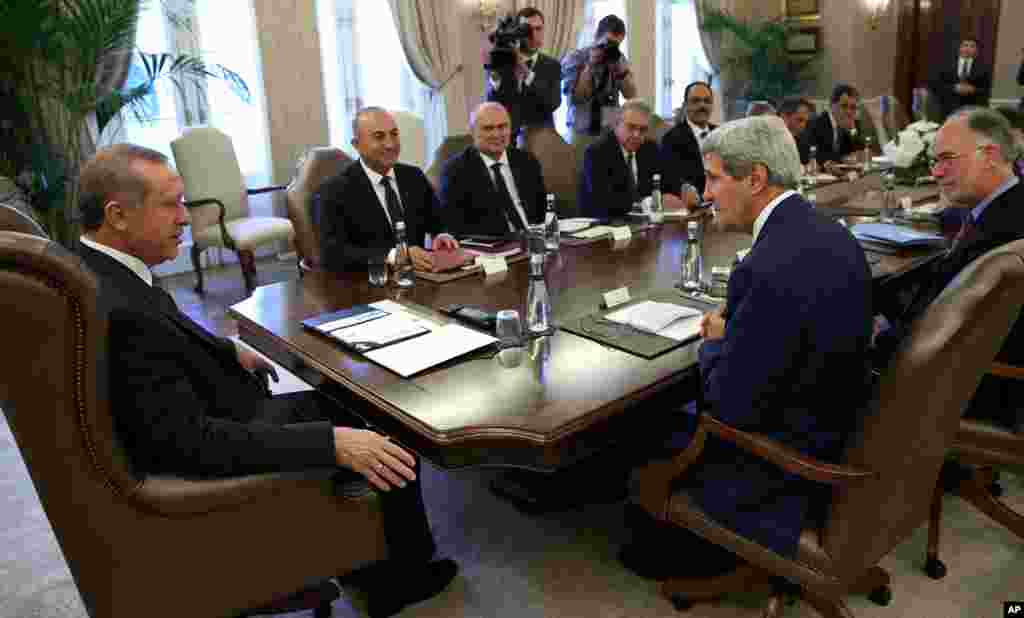 Turkish President Recep Tayyip Erdogan and U.S. Secretary of State John Kerry speak during a meeting in Ankara, Turkey, Sept. 12, 2014.