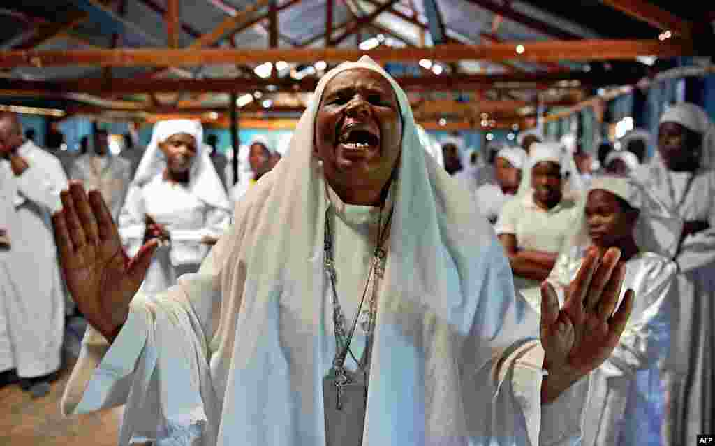 A woman screams during a special prayer for the victims of the Westgate Mall massacre at the Legio Maria African Mission church in Nairobi, Kenya. 