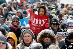 A young person holds a sign as Democratic Sen. Amy Klobuchar of Minnesota announces she is entering the race for president during a rally, Feb. 10, 2019, at Boom Island Park in Minneapolis, Minnesota.