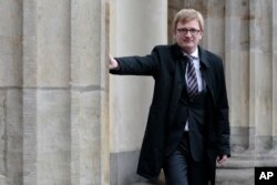 FILE - German member of parliament Philipp Lengsfeld poses near the columns of the Brandenburg Gate in Berlin, Germany, Oct. 30, 2014.