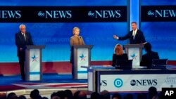 Martin O’Malley, right, speaks alongside Bernie Sanders, left, and Hillary Clinton, center, during a Democratic presidential primary debate at Saint Anselm College in Manchester, N.H., Dec. 19, 2015.