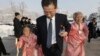 FILE - A North Korean man escorts his relatives as they reunite with their South Korean family members at Diamond Mountain resort in North Korea, Feb. 21, 2014.