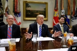 FILE - President Donald Trump, flanked by Senate Majority Leader Mitch McConnell (R-Kentucky), left, and House Speaker Paul Ryan (R-Wisconsin), speaks during a meeting in the Roosevelt Room of the White House in Washington, March 1, 2017. Trump is meeting with congressional Republican leaders Tuesday.