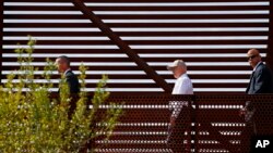 FILE - Attorney General Jeff Sessions, center, tours the U.S.-Mexico border with border officials in Nogales, Arizona, April 11, 2017. A courthouse on the border in Texas is serving as a model for the kind of tough immigration enforcement advocated by President Donald Trump.
