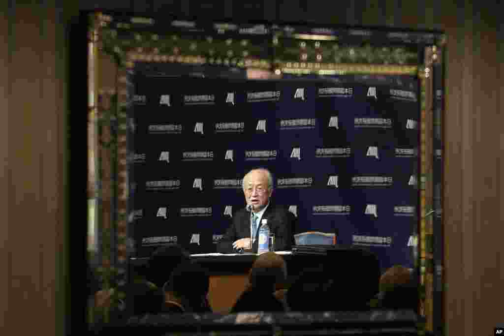 Director General of the International Atomic Energy Agency (IAEA) Yukiya Amano is reflected in a mirror as he delivers a speech at a forum hosted by the Japan Institute of International Affairs in Tokyo.