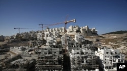 Houses under construction are seen in a Jewish settlement near Jerusalem known to Israelis as Har Homa and to Palestinians as Jabal Abu Ghneim, 08 Dec 2010