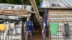 FILE - Police stand guard Oct. 5, 2021, near the office of top community Rohingya leader and activist Mohib Ullah, who was shot dead by gunmen, at Kutupalong refugee camp in Ukhia.