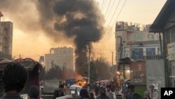 Smoke rises following a bomb explosion in Kabul, Afghanistan, Saturday, Nov. 13, 2021. Emergency workers say a bomb exploded on a minibus on a busy commercial street in a Kabul neighborhood populated by the Hazara community.