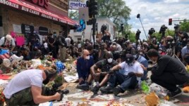 Terrence Floyd(C), the brother of George Floyd, an unarmed black man died May 25th in Minneapolis police custody, sits as people gather at the site of Floyd's death. June 1, 2020.