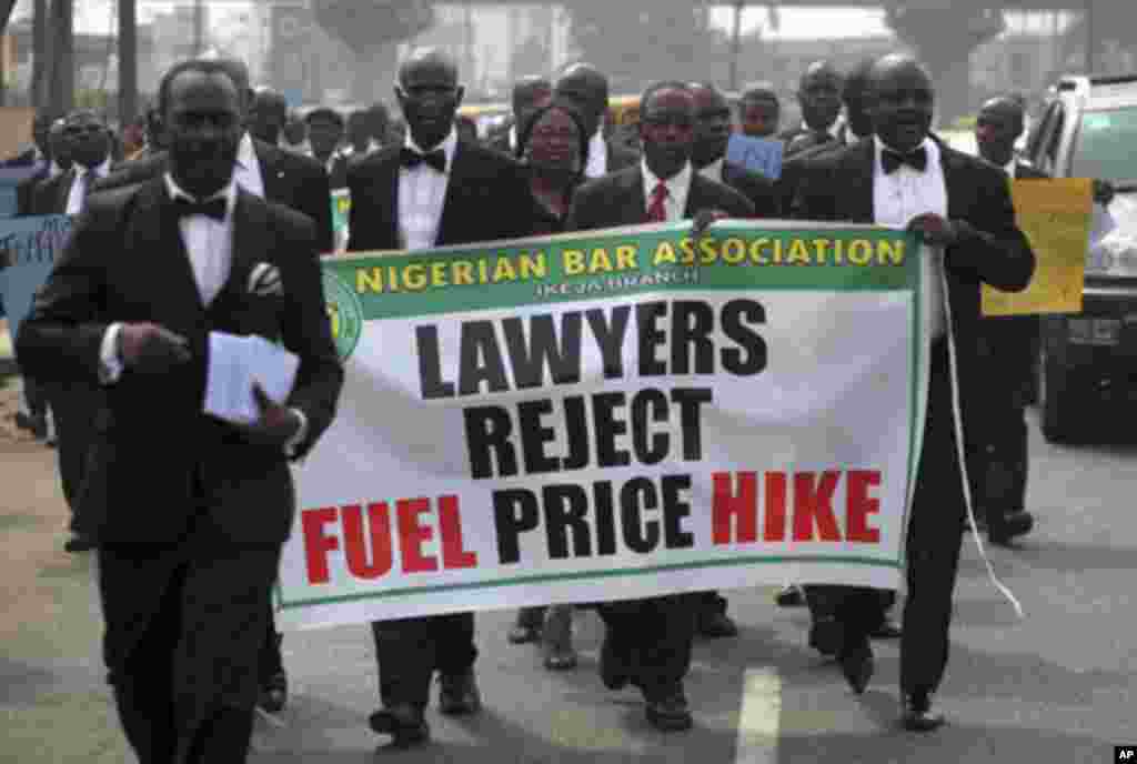 Members of the Nigerian Bar Association carry a banner as they walk along a street to protest a fuel subsidy removal, in Lagos January 5, 2012. Nigerian trade unions threatened on Wednesday to call a national strike and shut down large parts of the countr