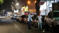 Doctors Carlos Martinez and Maria Martinez wait in line to get fuel at a gas station, during a nationwide quarantine due to the coronavirus disease (COVID-19) outbreak, in Caracas, Venezuela April 7, 2020.