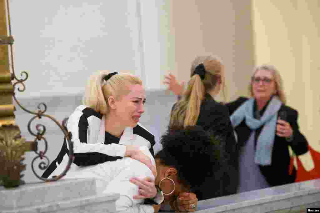 Bill Cosby accusers (L-R) Caroline Heldman, Lili Bernard and Victoria Valentino (R) react after the guilty on all counts verdict was delivered in the sexual assault retrial at the Montgomery County Courthouse in Norristown, Pennsylvania.