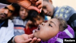 A girl is given vitamin A drops during a house-to-house vaccination campaign in Sanaa, Yemen February 20, 2017. 