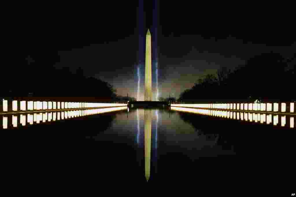 COVID-19 memorial lights are seen surrounding the Reflecting Pool and the Washington Monument in the background during the Celebrating America concert at the Lincoln Memorial in Washington, Jan. 20, 2021, after President Joe Biden&#39;s inauguration.