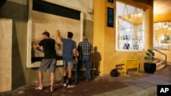 Residents cover windows with wood ahead of Hurricane Willa in Mazatlan, Mexico, Oct. 22, 2018. 