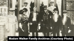 Madam C.J. Walker with Booker T. Washington and other men at the opening of a YMCA building in 1913.