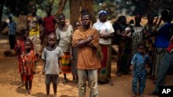 Christian families living in a refugee camp stand under a tree in Kaga-Bandoro, Central African Republic, Feb. 16, 2016.