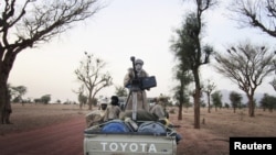 Militiaman from the Ansar Dine Islamic group ride on an armed vehicle between Gao and Kidal, northeastern Mali, June 12, 2012.
