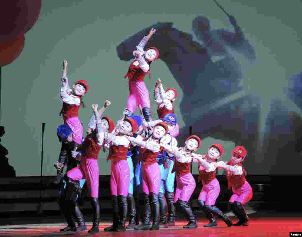In a photo released by North Korea's Korean Central News Agency, schoolchildren perform "We Are the Happiest in the World" at the Central Youth Hall for New Year's Eve festivities in Pyongyang.