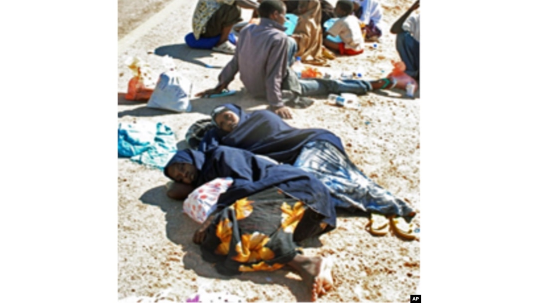 Somali asylum seekers rest on side of main road after an exhausting trip upon arrival on the beach of Hasn Beleid village, east of Red Sea port of Aden (file photo)