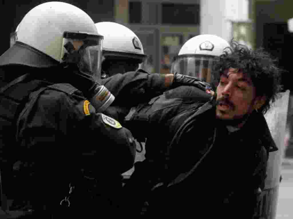 Riot police detain a protester during clashes in Athens, February 10, 2012. (AP)
