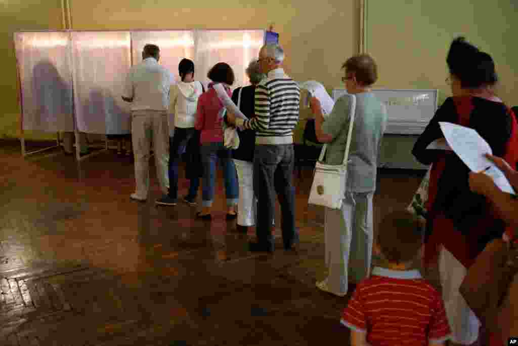 Local residents line up at a polling station during regional parliament and municipal elections in Simferopol, Crimea, the Ukrainian peninsula Russia annexed in March, Sept. 14, 2014.