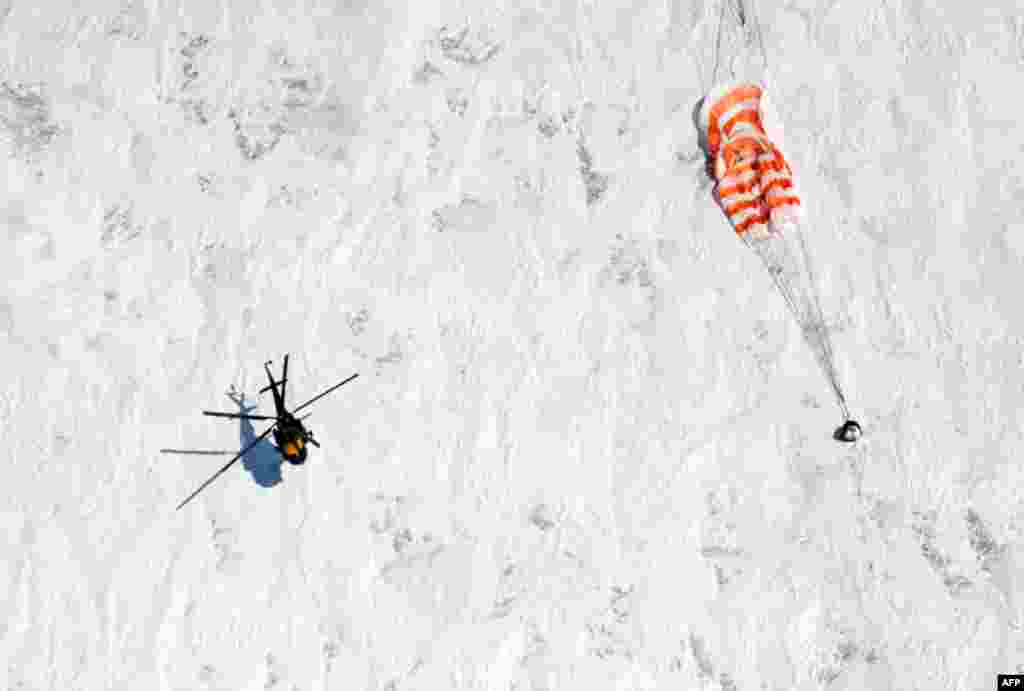 March 16: A rescue helicopter from the Russian space agency lands near the Soyuz TMA-01M spacecraft, near the town of Arkalyk. U.S. Astronaut Scott Kelly, Russian Cosmonauts Oleg Skripochka and Alexander Kaleri returned from six months onboard the Intern