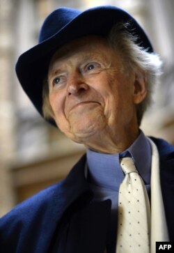 FILE - U.S. author and journalist Tom Wolfe smiles during the presentation of his new book "Bloody Miami" at the La Pedrera building in Barcelona, Dec. 10, 2013.
