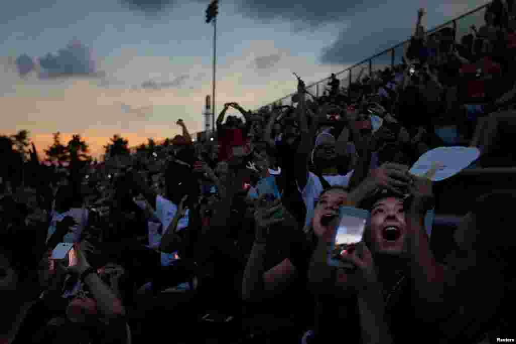 Guests reacts to the total eclipse in the football stadium at Southern Illinois University in Carbondale, Illinois, August 21, 2017. 