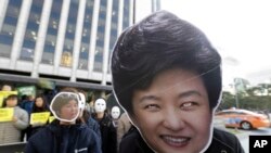 Manifestants portant des masques représentant Park Geun-hye (à droite) et Choi Soon-sil (à gauche), Seoul, Corée du sud, le 2 novembre 2016. 